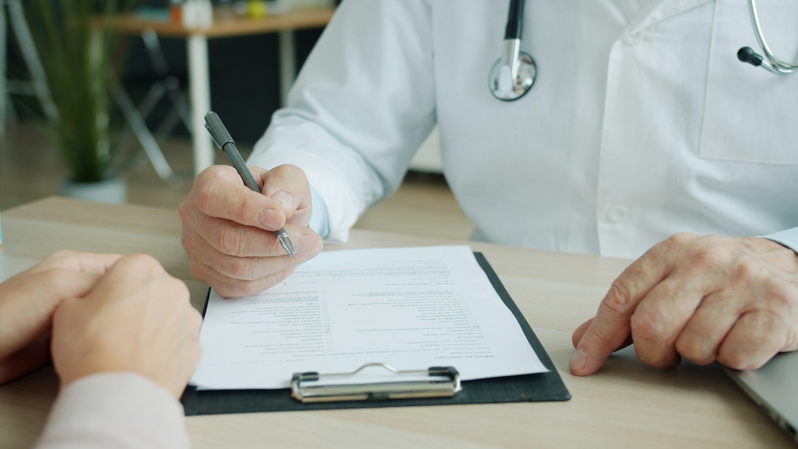Clinician filling out a patient chart