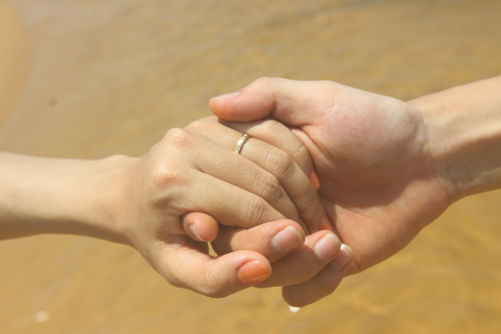 Two people holding hands in support